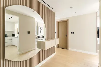 a living room with a large mirror on the wall at VayK - Luxurious 2BR in JVC in Dubai