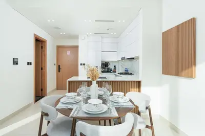 a dining room with a table and chairs at PVH - Serene 1BR with City View - Binghatti House in Dubai