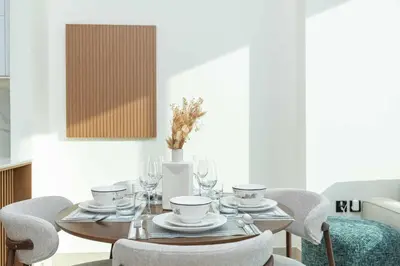 a dining room with a table and chairs at PVH - Serene 1BR with City View - Binghatti House in Dubai