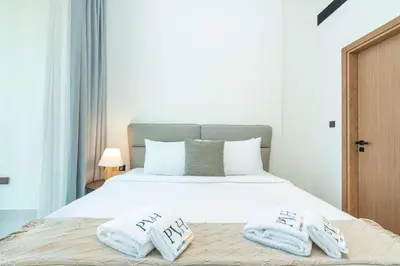 a bedroom with a bed with two pillows on it at PVH - Cozy 1BR with City View - Binghatti House in Dubai