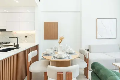 a kitchen and dining room with a table and chairs at PVH - Cozy 1BR with City View - Binghatti House in Dubai