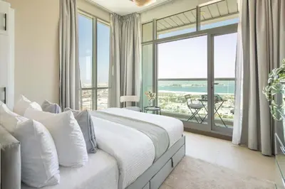 a bedroom with a bed with a view of the ocean at Frank Porter - Hilliana Tower in Dubai