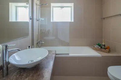 a bathroom with a sink and a tub and a toilet at Frank Porter - Hilliana Tower in Dubai