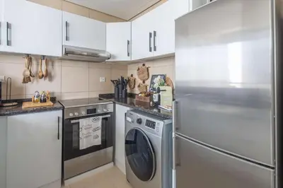 a kitchen with a stainless steel refrigerator and a dishwasher at Frank Porter - Hilliana Tower in Dubai