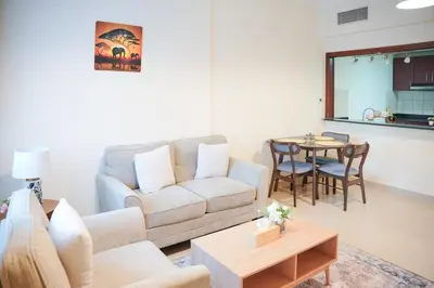 a living room with a couch and a table at 1 Bedroom Apartment at Marina with Stunning View in Dubai