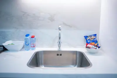 a kitchen counter with a sink and some food at AWS Holiday Homes - Comfy Cozy Studio in Dubai
