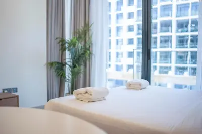 a hotel room with a bed with towels on it at AWS Holiday Homes - Comfy Cozy Studio in Dubai