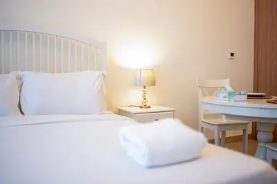 a bedroom with a bed and a desk with a lamp at AWS Holiday Homes - Comfy Cozy Studio in Dubai