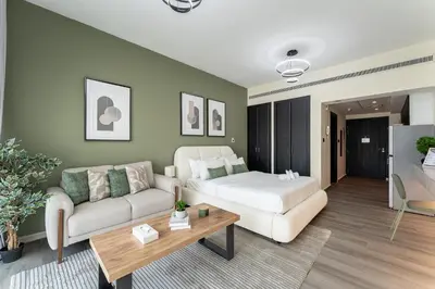 a living room with a couch and a table at HAVN - Studio in Alka, The Greens in Dubai