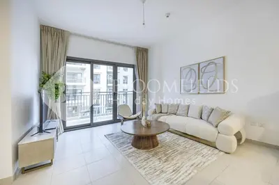 a living room with a couch and a table at Bloomfields Cozy 1br Apt Town Square in Dubai