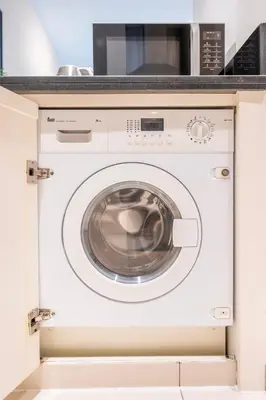 a washer and dryer in a kitchen at Chic 1 Bedroom in Business Bay in Dubai