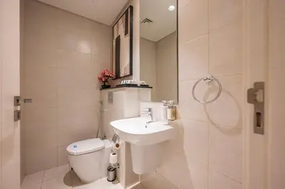 a bathroom with a toilet and a sink at Chic 1 Bedroom in Business Bay in Dubai
