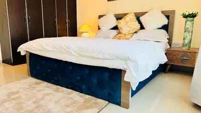 a bedroom with a large bed with two stuffed animals at Beautiful 1 Bedroom Apartment close to metro in Dubai