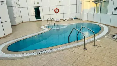 a large swimming pool in a building at Beautiful 1 Bedroom Apartment close to metro in Dubai