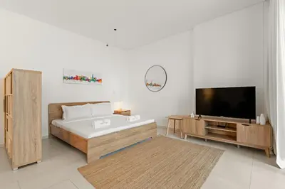a living room with a tub and a television at FIRST CLASS Studio Marquise Bliss in Dubai
