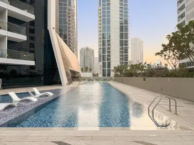 a swimming pool in a building with tall buildings at FIRST CLASS Studio Marquise Bliss in Dubai