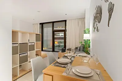 a dining room with a wooden table and chairs at FIRST CLASS Studio Marquise Bliss in Dubai