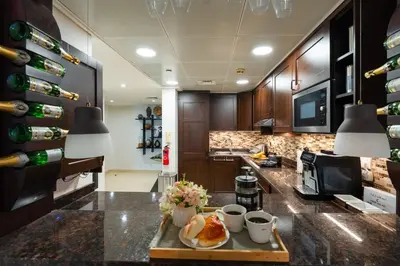 a kitchen with a table with a plate of food on it at Comfortable - Vibrant - Convenient in Dubai