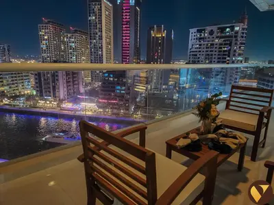 a balcony with a view of a city at night at Vogue Marina Dorra Bay near JBR Beach and Ain Dubai, Two Bedroom apartment with Balcony, Canal and Skyline View, Access to all Amenities in Dubai