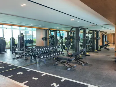 a gym with rows of treadmills and machines at Luxury Studio with Private Jacuzzi &Canal View in Dubai
