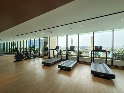 a gym with a bunch of exercise equipment in a building at Luxury Studio with Private Jacuzzi &Canal View in Dubai