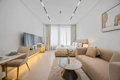a living room with a couch and a table at Luxury Studio with Private Jacuzzi &Canal View in Dubai