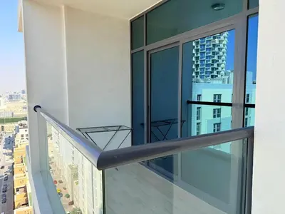 a balcony with a view of a city at Mahenti - Spacious 1-Bedroom Apartment in JVC in Dubai