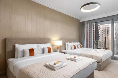a hotel room with two beds and a large window at Luxury 1st Row Burj Khalifa and Fountain Views, Walk to Dubai Mall in Dubai