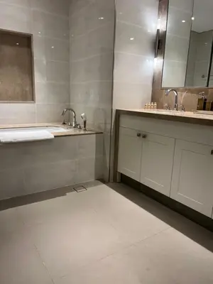 a bathroom with two sinks and two mirrors at Luxury 1st Row Burj Khalifa and Fountain Views, Walk to Dubai Mall in Dubai