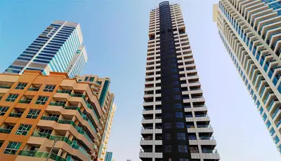 two tall buildings standing next to each other at Locations l Upgraded 1 Bedroom l Marina Views l Free Pool Access in Dubai