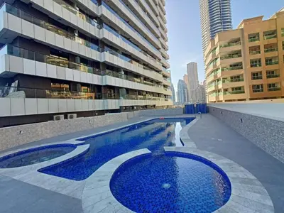 a swimming pool in the middle of a building at Locations l Upgraded 1 Bedroom l Marina Views l Free Pool Access in Dubai