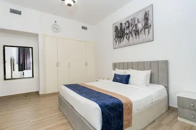 a bedroom with a large bed with a blue blanket at CitiHome - Modern & Stylish 1BR in Dubai Marina in Dubai