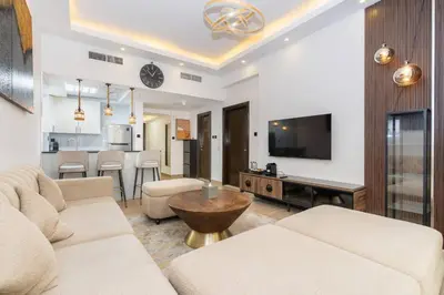 a living room with a couch and a tv and a table at CitiHome - Modern & Stylish 1BR in Dubai Marina in Dubai