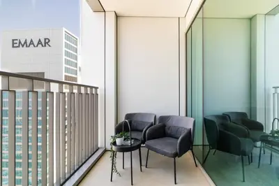 a balcony with chairs and a table and a building at CitiHome Luxury 1BR - Downtown Views 2 High Floor in Dubai