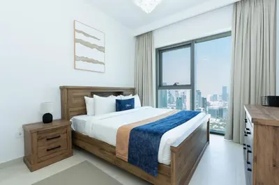a bedroom with a bed and a large window at CitiHome Luxury 1BR - Downtown Views 2 High Floor in Dubai