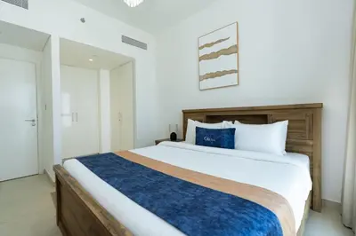 a bedroom with a large bed with blue accents at CitiHome Luxury 1BR - Downtown Views 2 High Floor in Dubai
