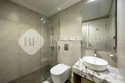 a bathroom with a white toilet and a sink at Bloomfields Magnificent STU Aykon City in Dubai