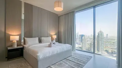 a bedroom with a large bed and a large window at Waterfront 1BR, Full Marina View & Pool Access - 34AB04 in Dubai
