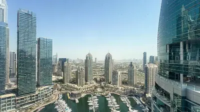 a view of a city with boats in a harbor at Waterfront 1BR, Full Marina View & Pool Access - 34AB04 in Dubai