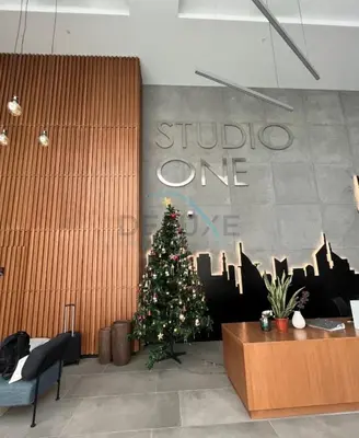 a christmas tree in the lobby of a store at Stylish 2BR Stay Near Marina Beach and Ain Dubai, Steps from Shops and Restaurants, Studio One, Dubai Marina by Deluxe Holiday Homes in Dubai