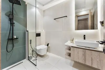 a bathroom with a shower and a toilet and a sink at 2 Bed With Balcony Near World Renowned Golf Clubs in Dubai