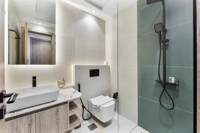a bathroom with a shower and a toilet and a sink at 2 Bed With Balcony Near World Renowned Golf Clubs in Dubai