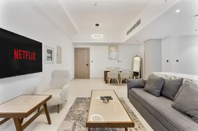 a living room with a couch and a table at 2 Bed With Balcony Near World Renowned Golf Clubs in Dubai
