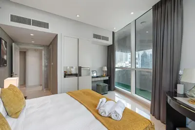 a bedroom with a bed and a large window at Luxe 2 Bedroom Near Dubai Mall DAMAC Uppercrest Downtown - Free Parking in Dubai