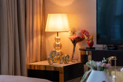 a table with a lamp and a sign that says love at Luxe 2 Bedroom Near Dubai Mall DAMAC Uppercrest Downtown - Free Parking in Dubai