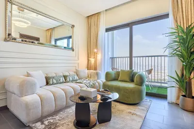 a living room with a couch and chairs and a large window at STAY BY LATINEM Luxury 1BR Plus Holiday Home CB 2408 Near Burj Khalifa in Dubai