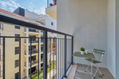 a balcony with a table and a building at GuestReady - Chic coastal living at Port de La Mer in Dubai