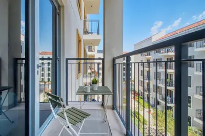 a balcony with a table and a chair at GuestReady - Chic coastal living at Port de La Mer in Dubai
