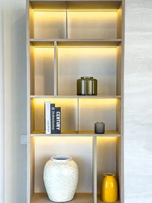 a shelf with a vase and other items on it at Liv Marina Panoramic 3BR with Palm & Sea View in Dubai