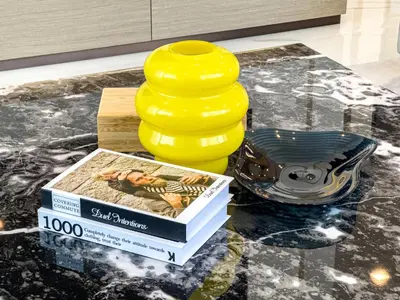 a yellow vase sitting on top of a table at Liv Marina Panoramic 3BR with Palm & Sea View in Dubai